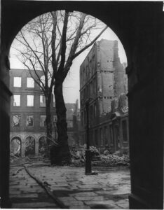 View through an archway into Pump Court with the buildings destroyed