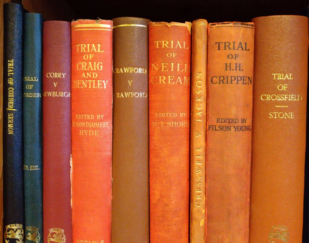 Image of spines of books in a row with the Trial of Corder the first two books in blue binding. The other titles include Trial of Craig and Bentley, H.H. Crippen and Crossfield & Stone