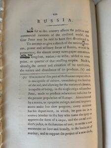 Page of an open book with text, some crossed out and changed. Title is Russia.