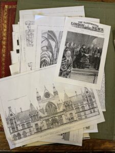 Pile of paper with drawing of the exterior of a building and an image of Queen Victoria on The Illustrated London News 