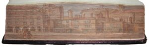 Pages of the book fanned out showing a colour painting of buildings with Temple Church amongst them.