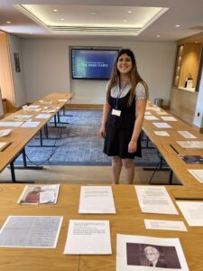 Woman stood in the middle of some tables with items displayed on the tables
